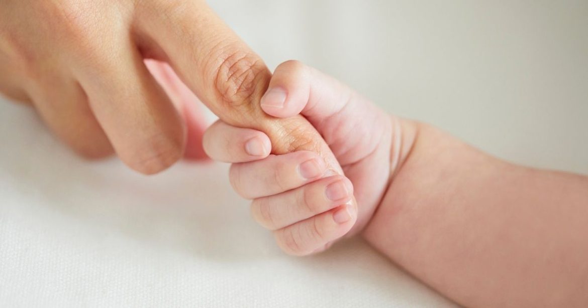 baby hand grabs finger