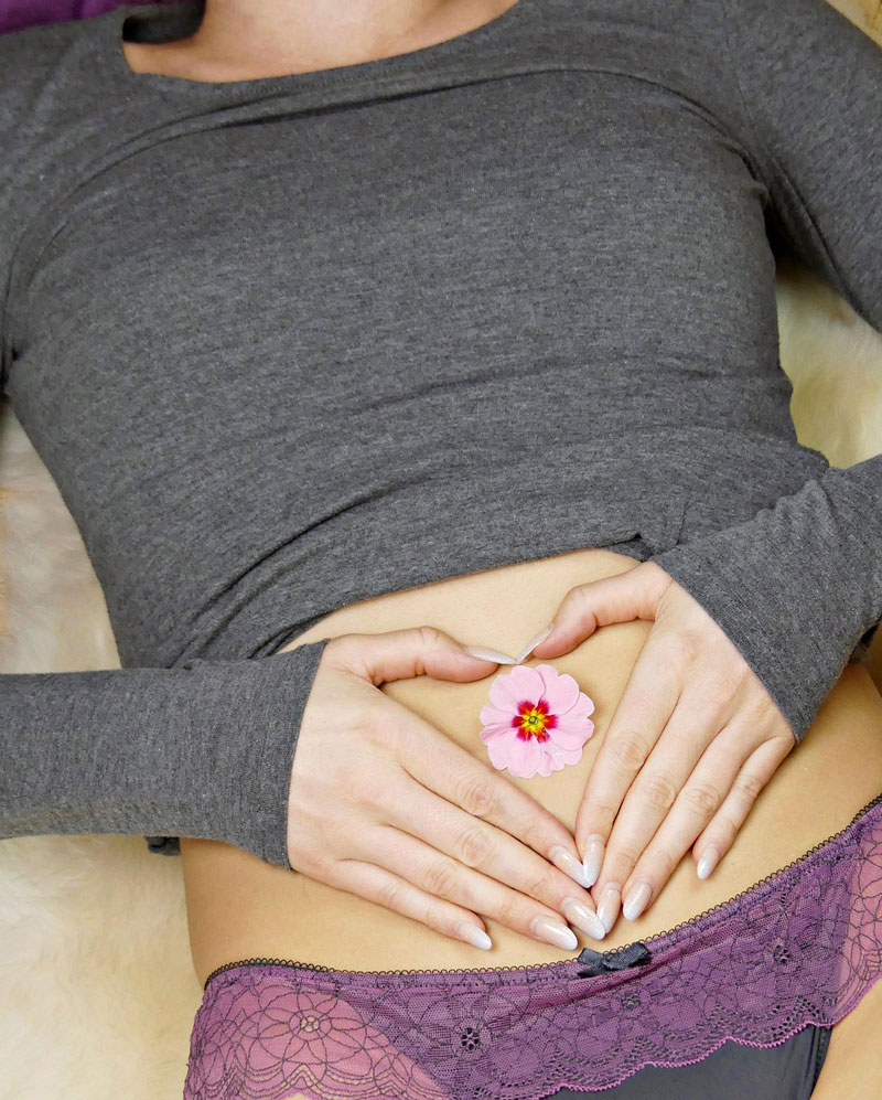 Woman with flower on belly