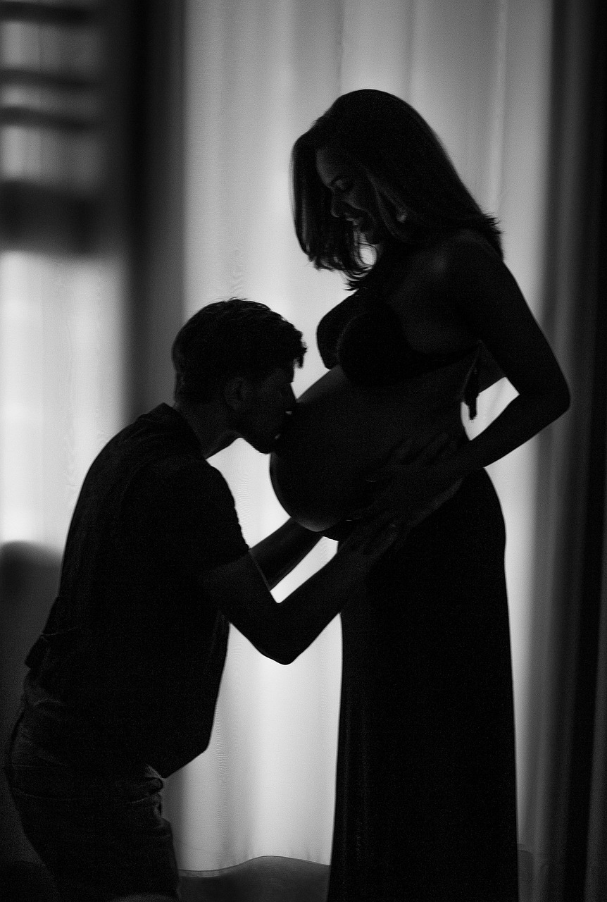 Man kiss pregnant belly