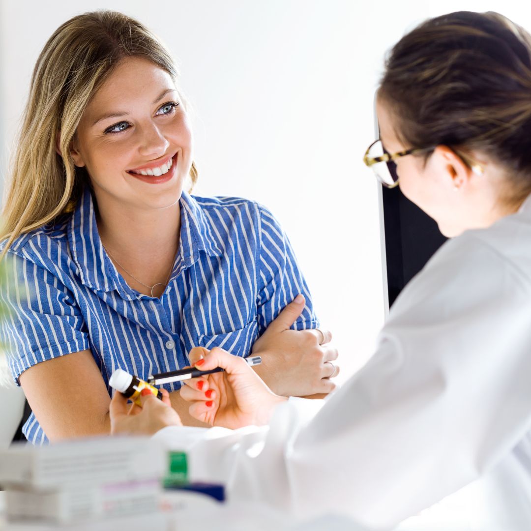 woman smiles with doctor