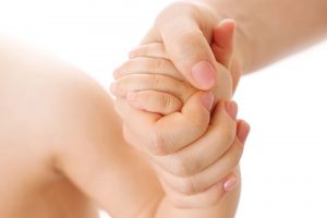 Gentle handhold symbolizes emotional support during egg freezing in Greece, offering comfort for women planning future parenthood.