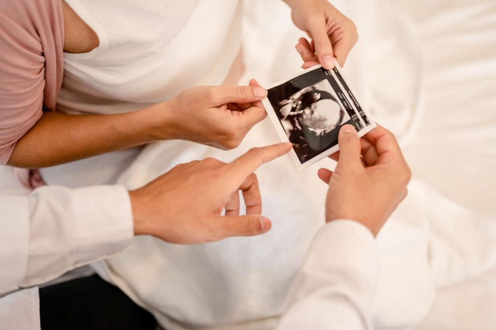 A doctor and patient examine an ultrasound image together, illustrating the IUI success evaluation process at FertUlity clinic.