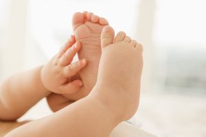 Tiny newborn feet and hands, symbolizing the joyful outcome of a successful IVF journey.
