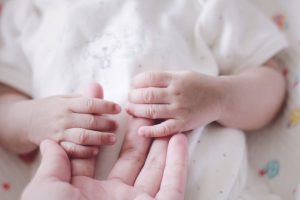 Newborn baby’s tiny hands held gently by parents after successful MACS IVF, symbolizing hope, care, and the beginning of new life.
