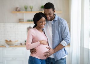 Pregnant couple smiling with hope after successful MACS IVF treatment, celebrating their journey to parenthood with healthy sperm selection.